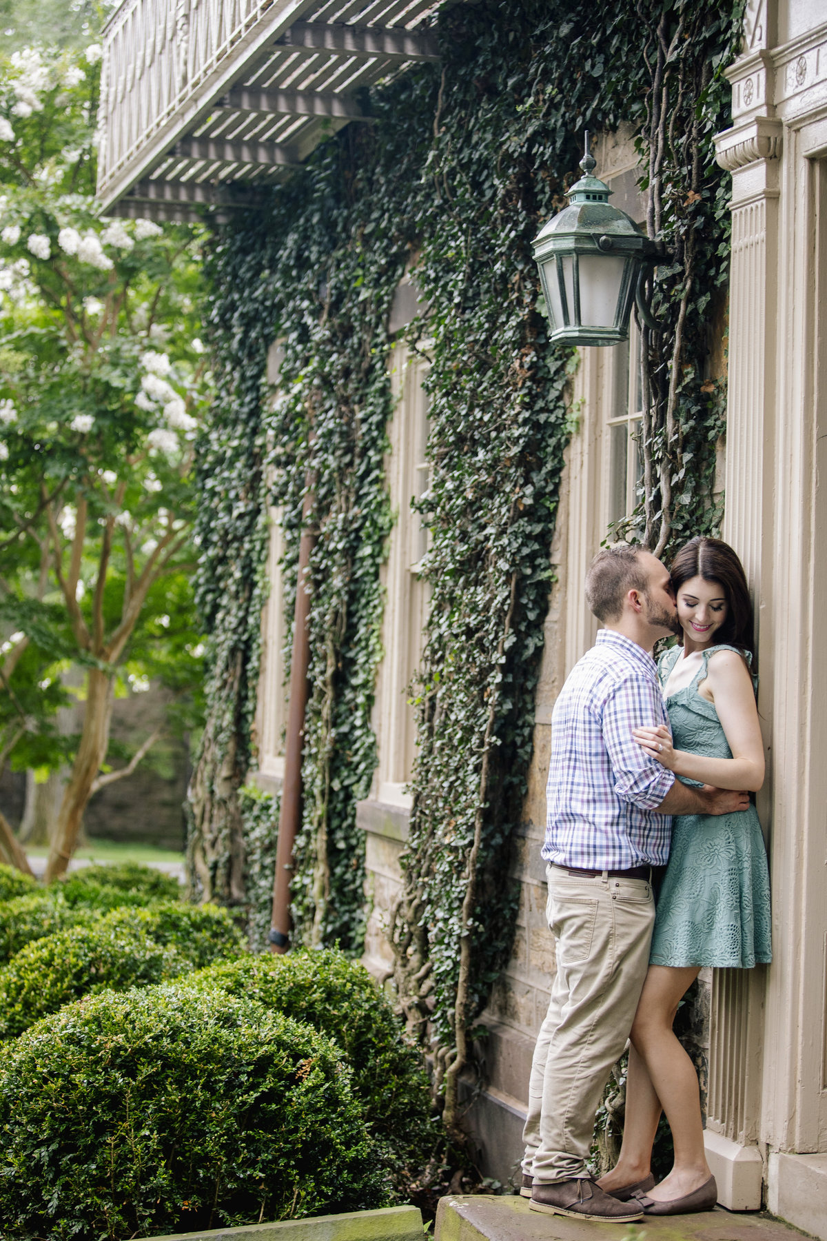 engaged couple kiss by ivy building at princeton university