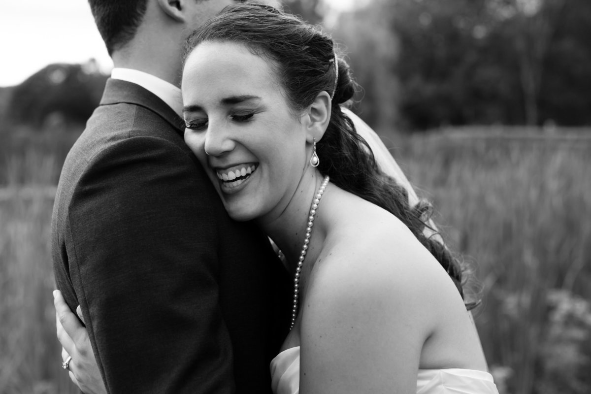 The bride laughs with her groom after their ceremony at Clark's Cove Farm in Maine