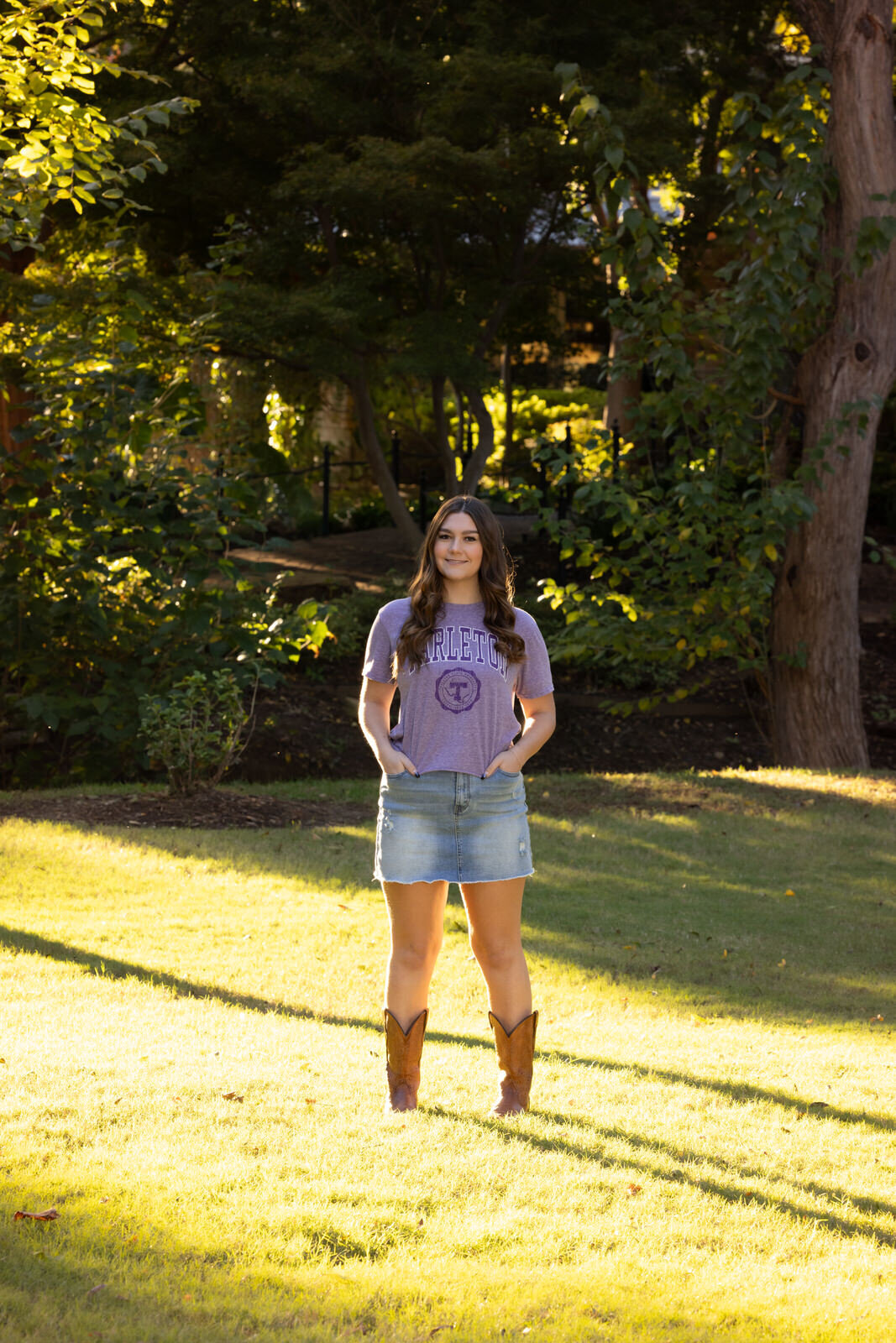 senior-girl-standing-with-boots-in-grass-in-sun