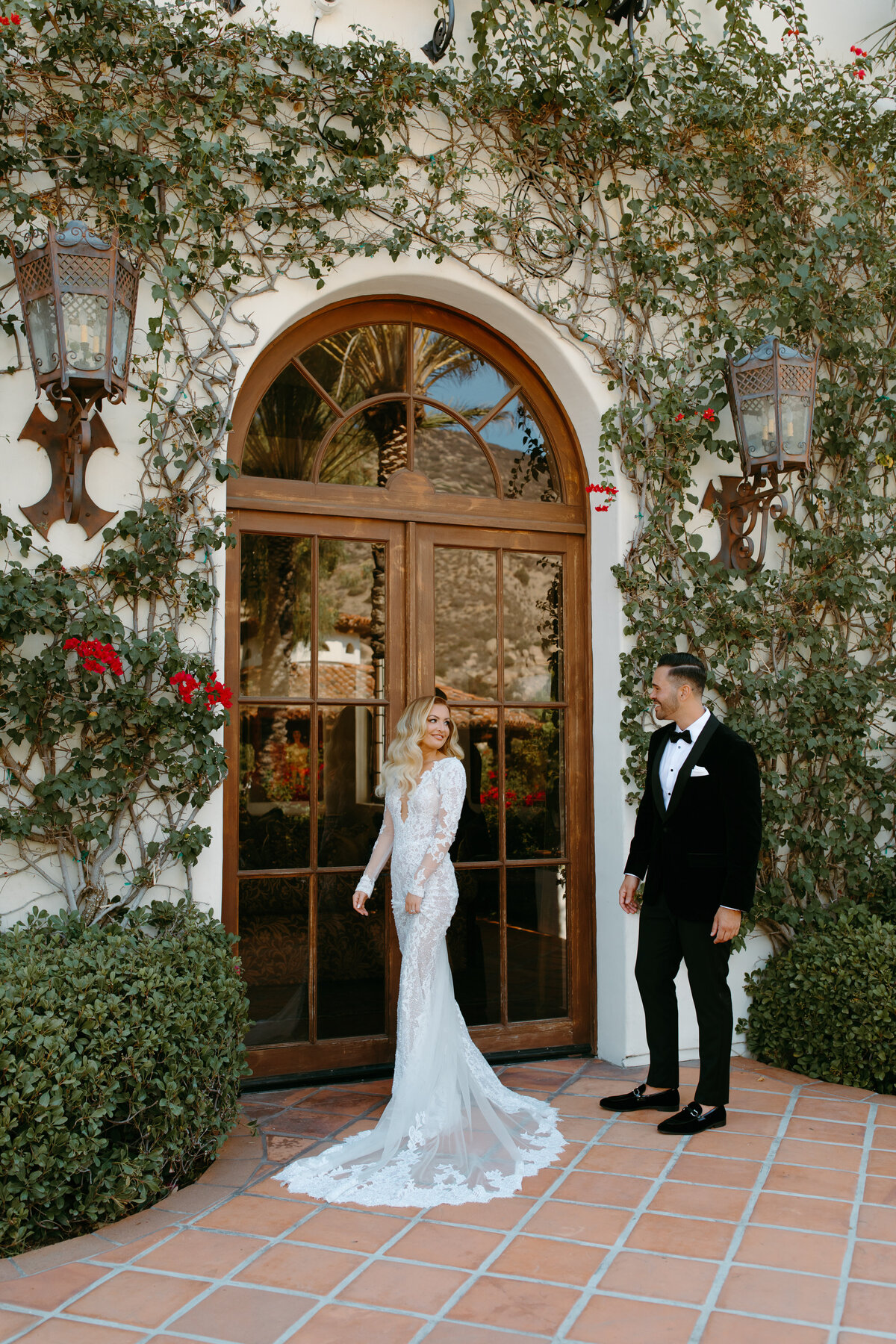 Bride has a first look with her groom and shows off her beautiful long sleeve gown