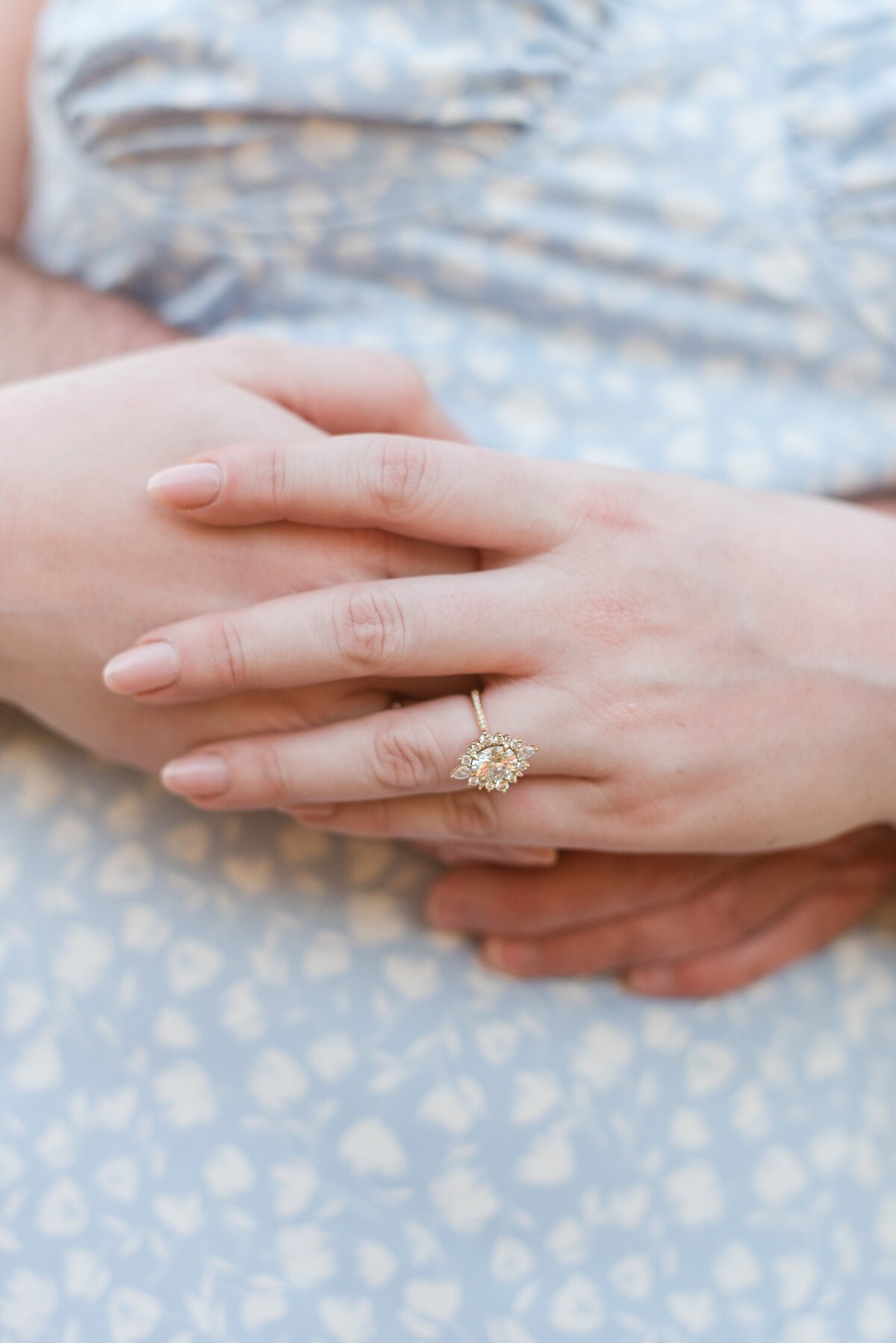 close-up of hands with engagement ring