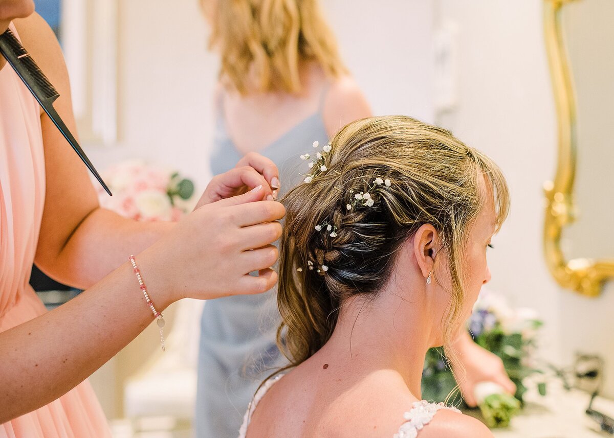 bride getting babies breath flowers in hair at Disney's Wedding Pavilion