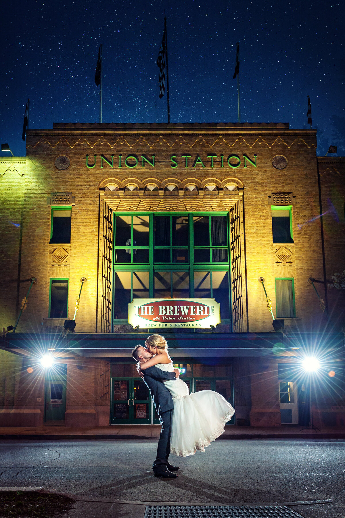 Wedding couple dancing in front of The Brewery at night.