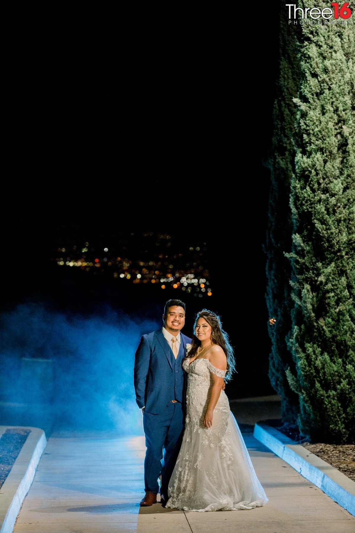 Bride and Groom pose together for a night shot