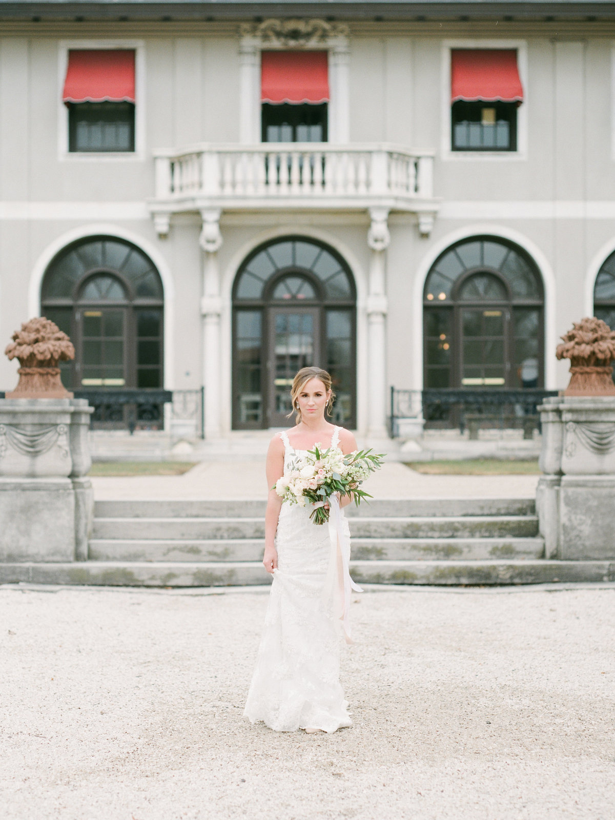 bride walking in front of mansion