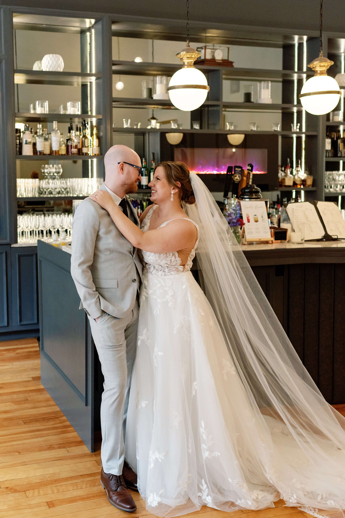 Bride and groom kissing in front of the bar at  at Halifax Club wedding in Nova Scotia