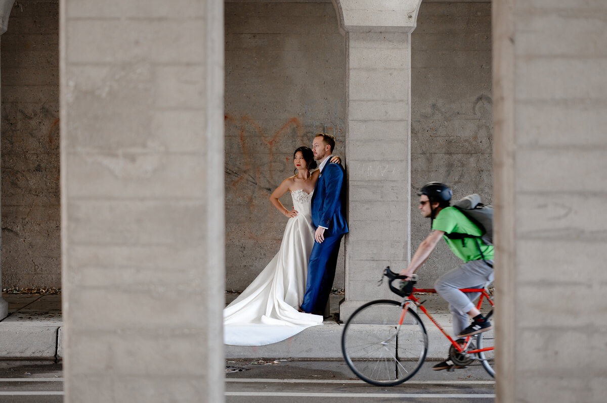 Biker rides past bride and groom
