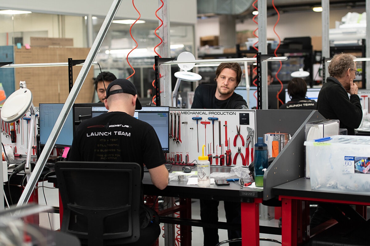 Rocket lab's Auckland Production Centre. Engineering team at work on bench.