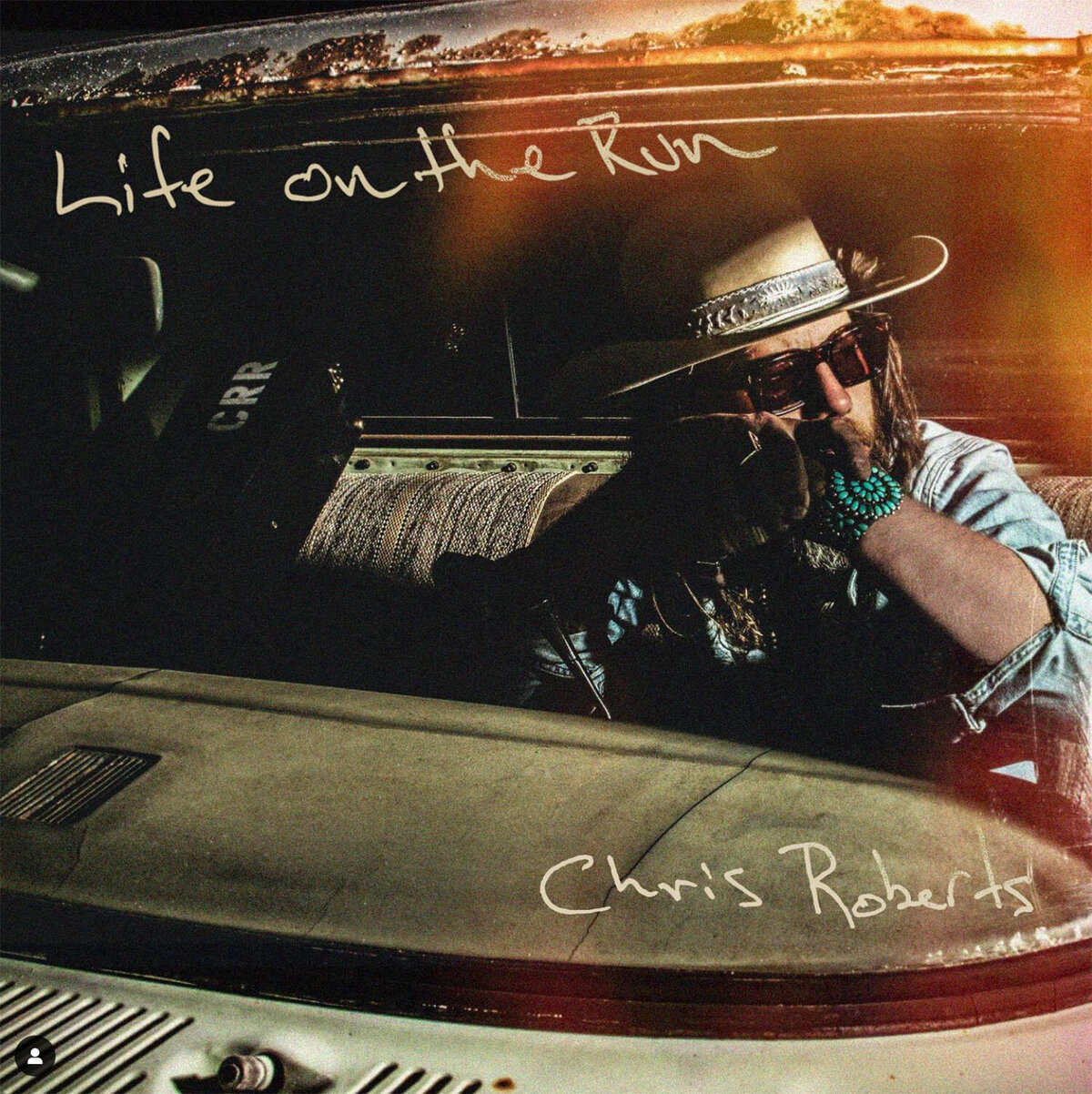 Single Cover Life on the Run country singer Chris Roberts leaning on steering wheel in old truck at night
