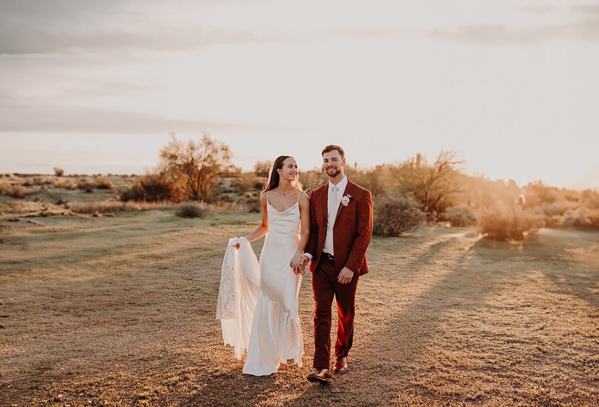 Bride and Groom walk together at sunset in Phoenix desert