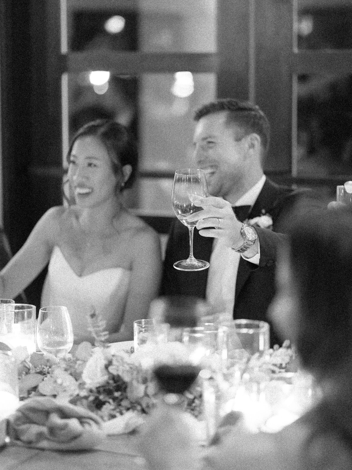 Bride and groom laughing at dinner photographed by Chicago editorial wedding photographer Arielle Peters