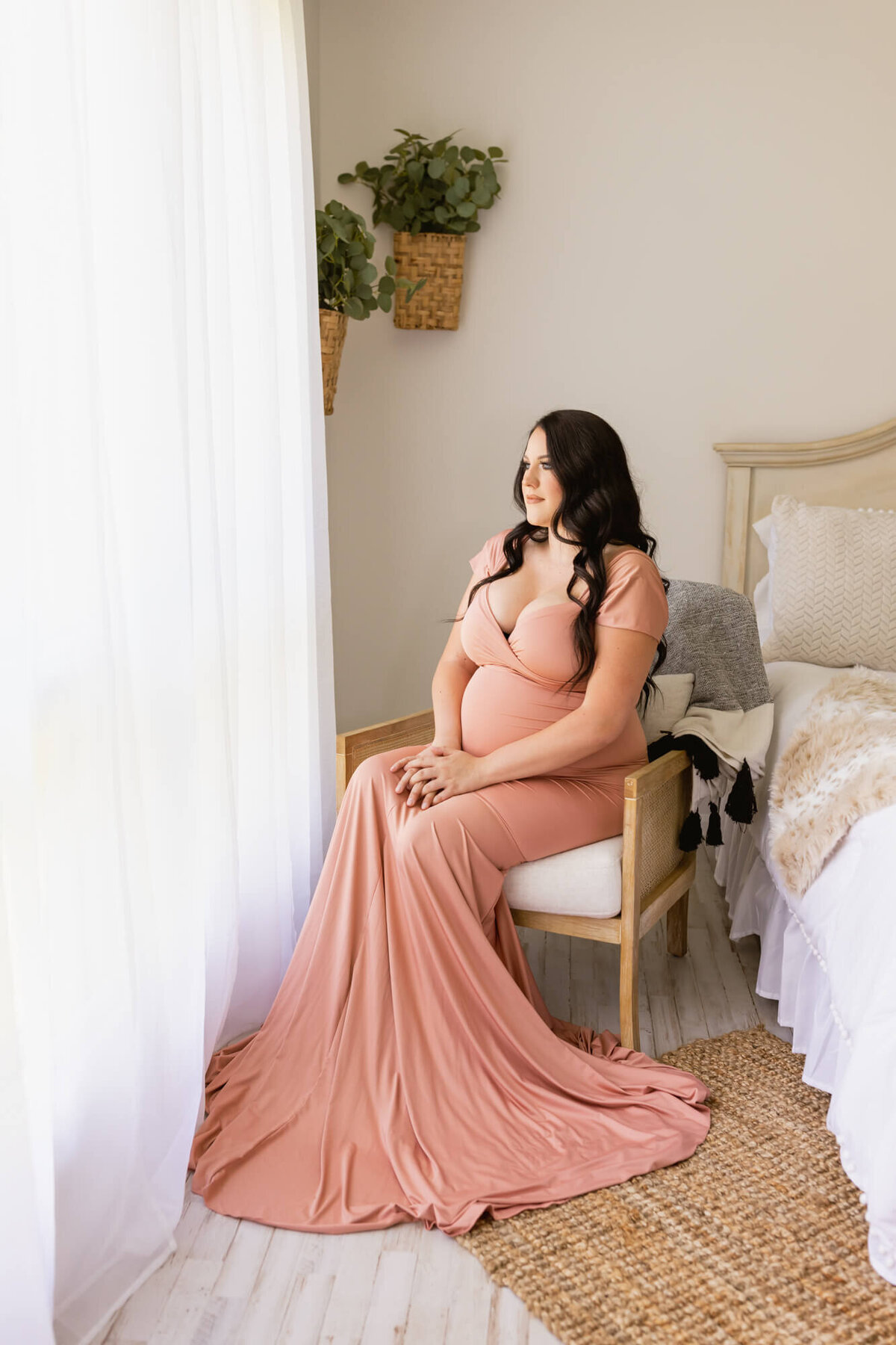 Expectant mom in a rose gold maternity dress