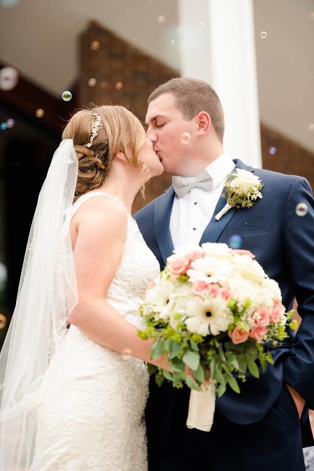 A newlywed couple shares a kiss