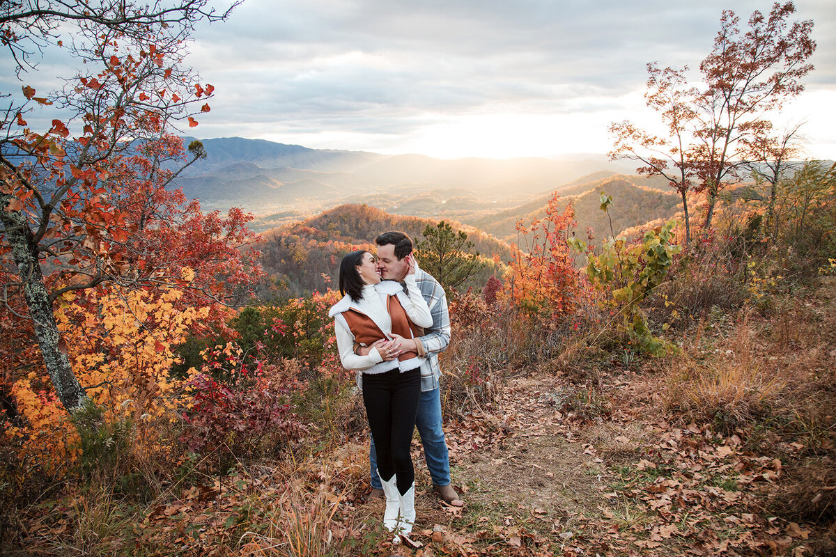 Couple about to kiss with the Smoky Mountians behind them