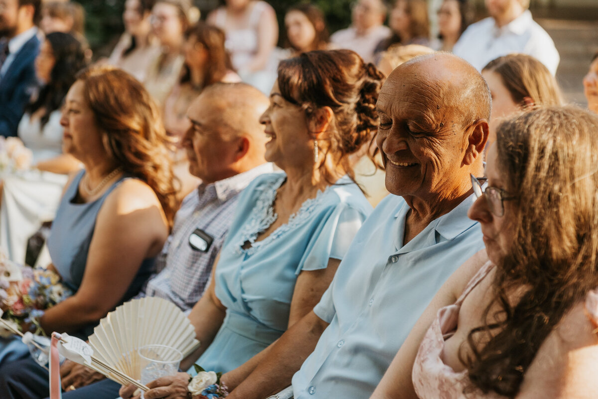 Guests laughing during a wedding ceremony 