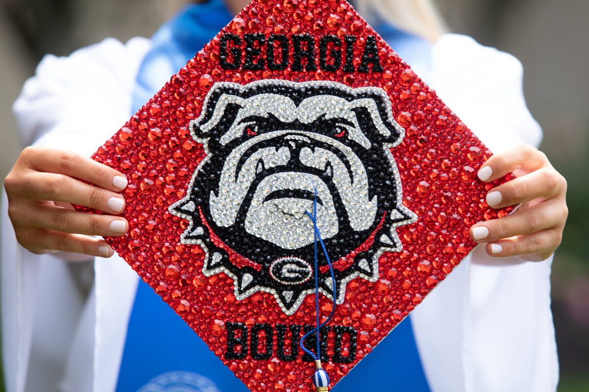 Detail shot of a graduation cap decorated with sequins and a mascot for Georgia Tech Pearl River senior portrait photographer Milestone Images