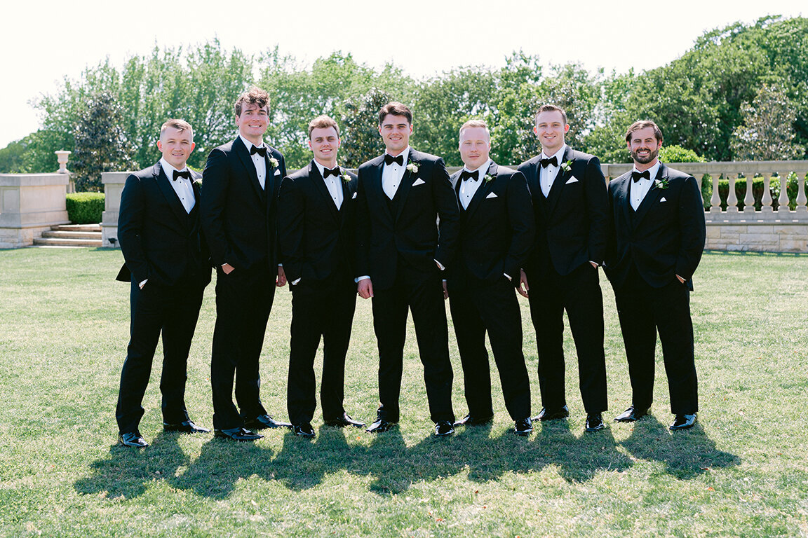 Groom with groomsmen in black suits at  Dallas wedding at The Olana
