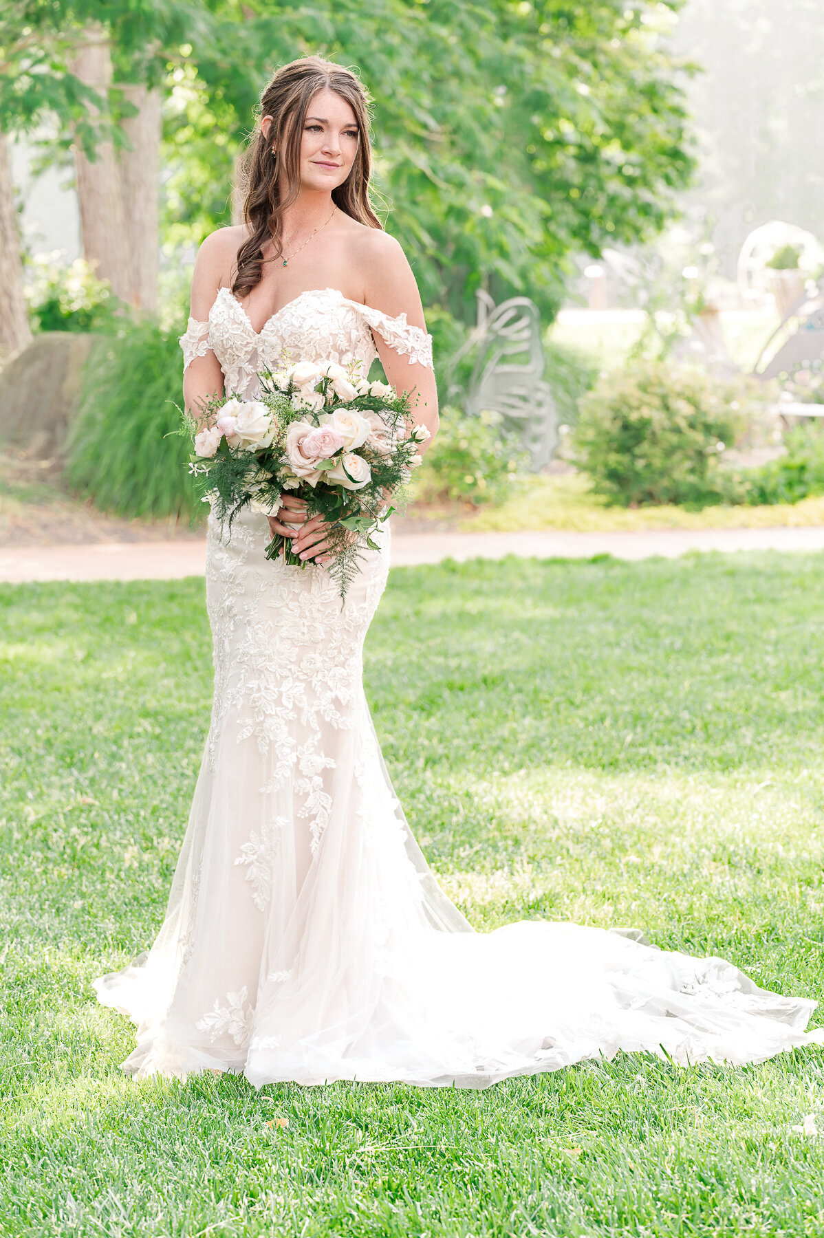 A brunette bride at her bridal session in a Raleigh garden enjoying her North Carolina wedding photos by JoLynn Photography