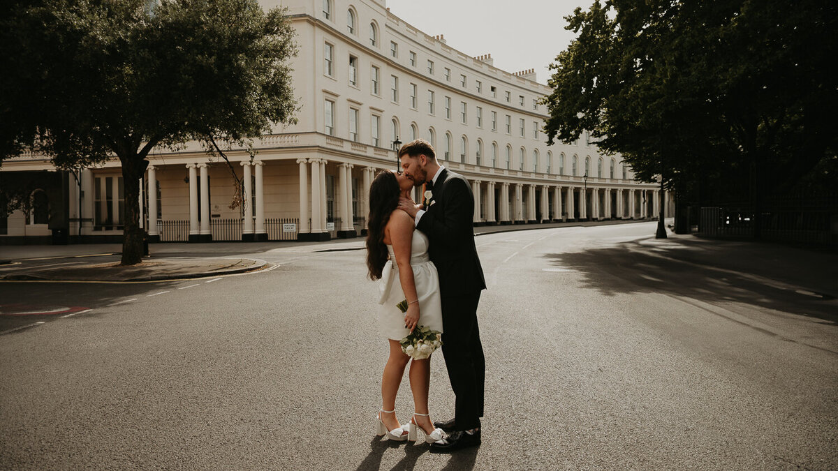 A bride and groom kiss at Regents Curve after their wedding ceremony at The Old Marylebone Town Hall. 