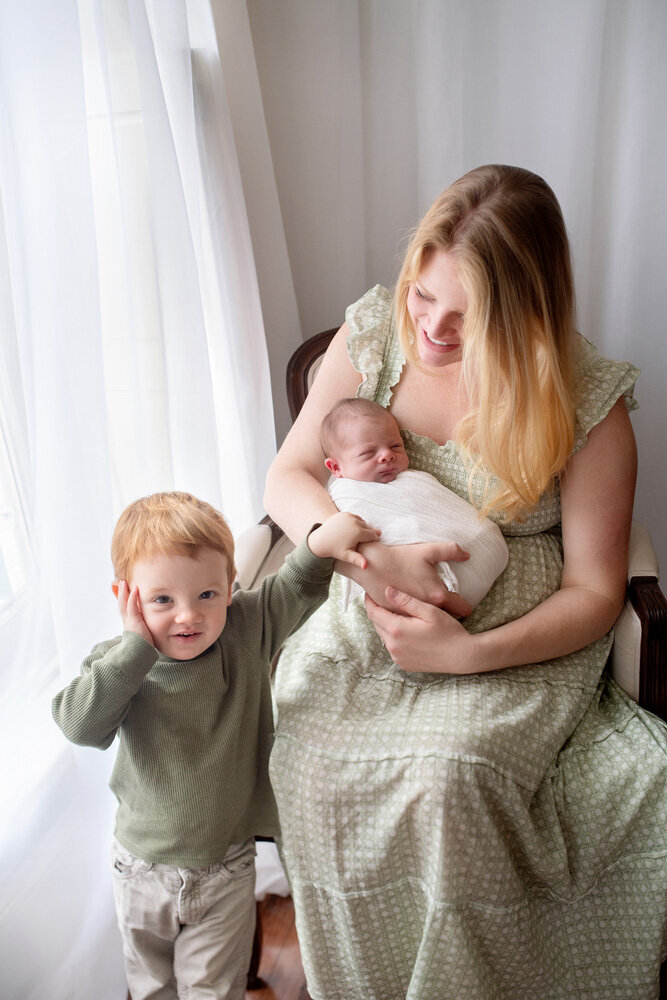 Newborn session with older brother and mother in dress