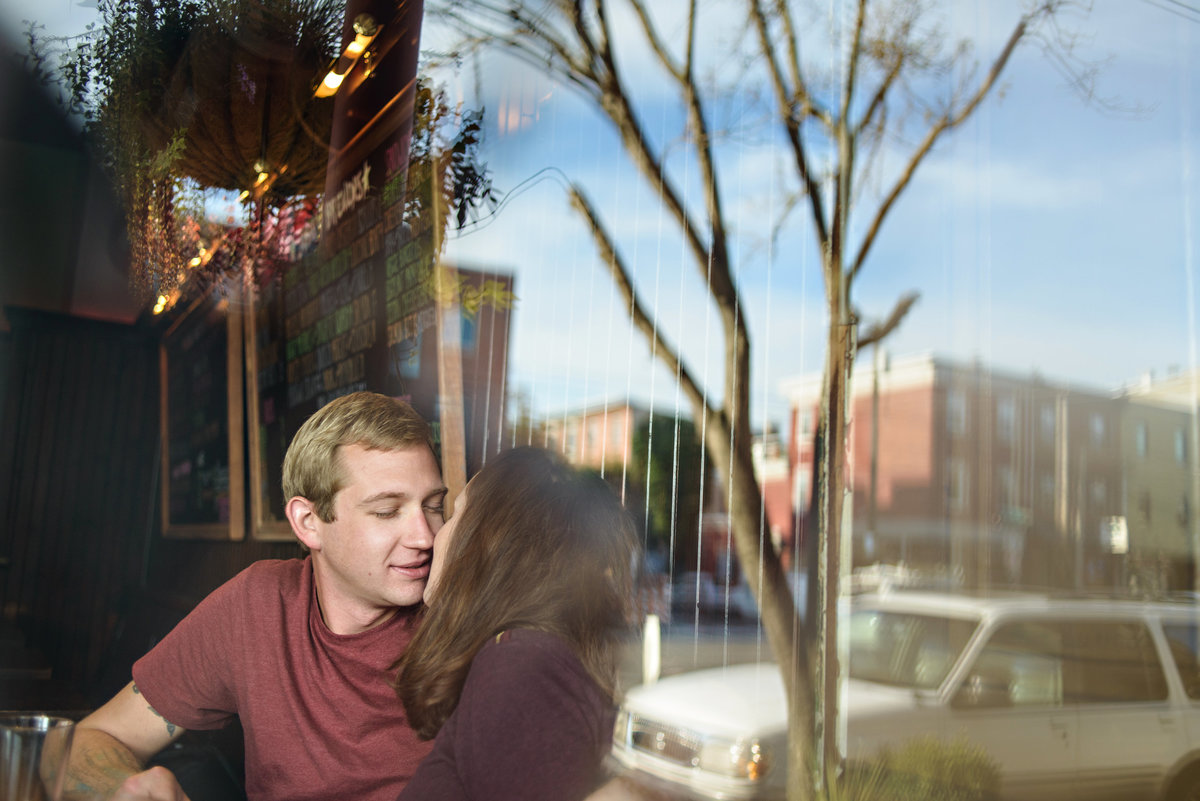 Reflection of the city of philly frames a couple in love.