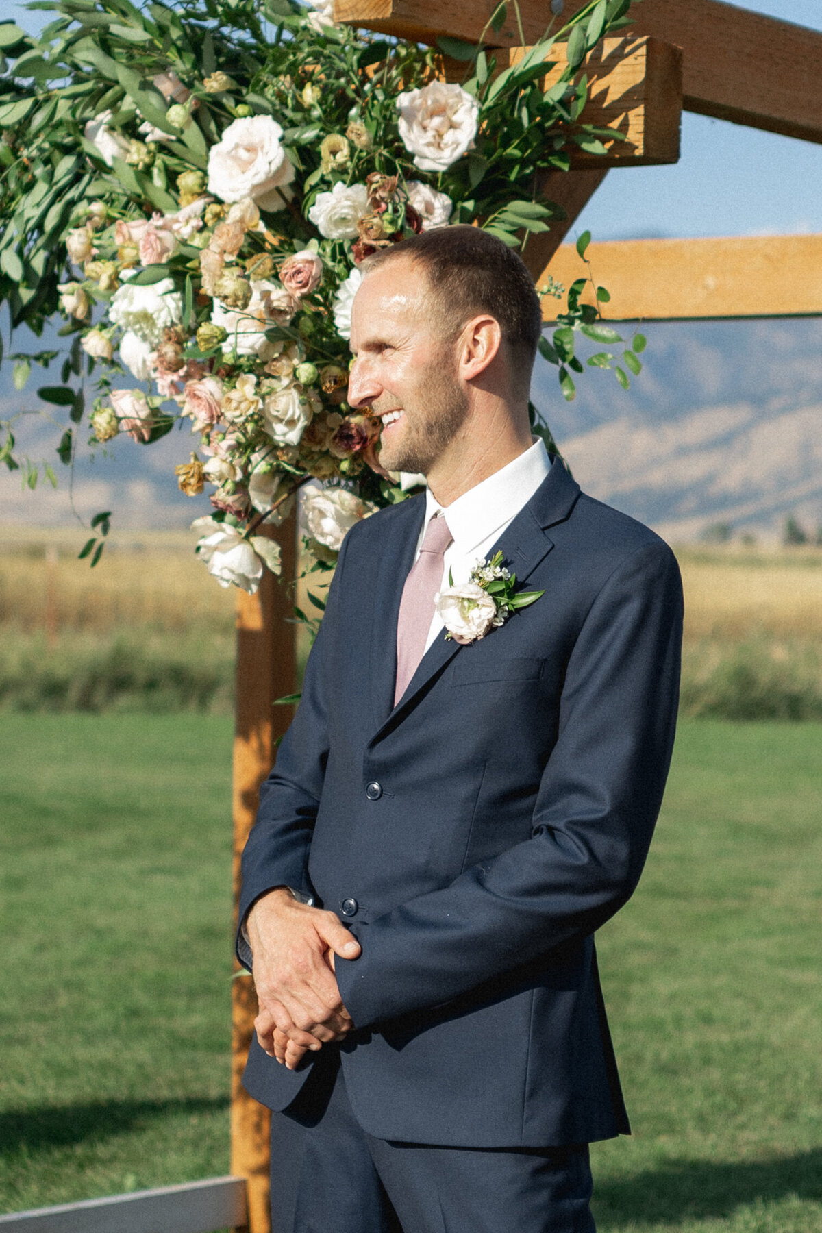 Groom waiting for bride at mountain wedding