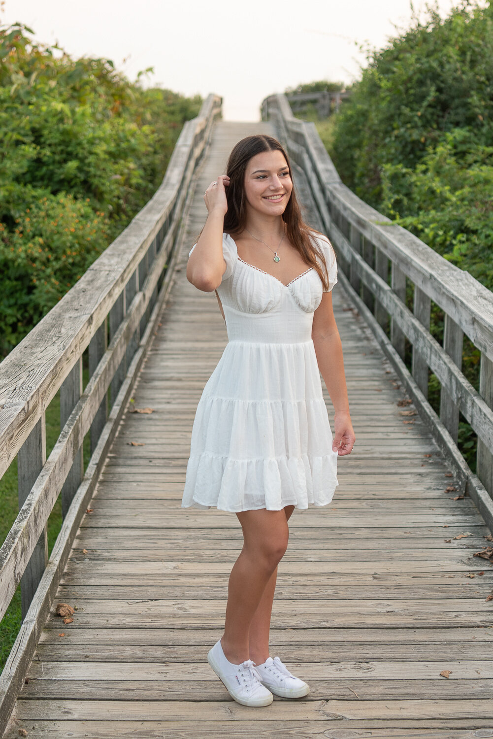 Young woman in white dress standing on board walk at Harkness Park for senior photography session |Sharon Leger Photography | Canton, CT Newborn & Family Photographer