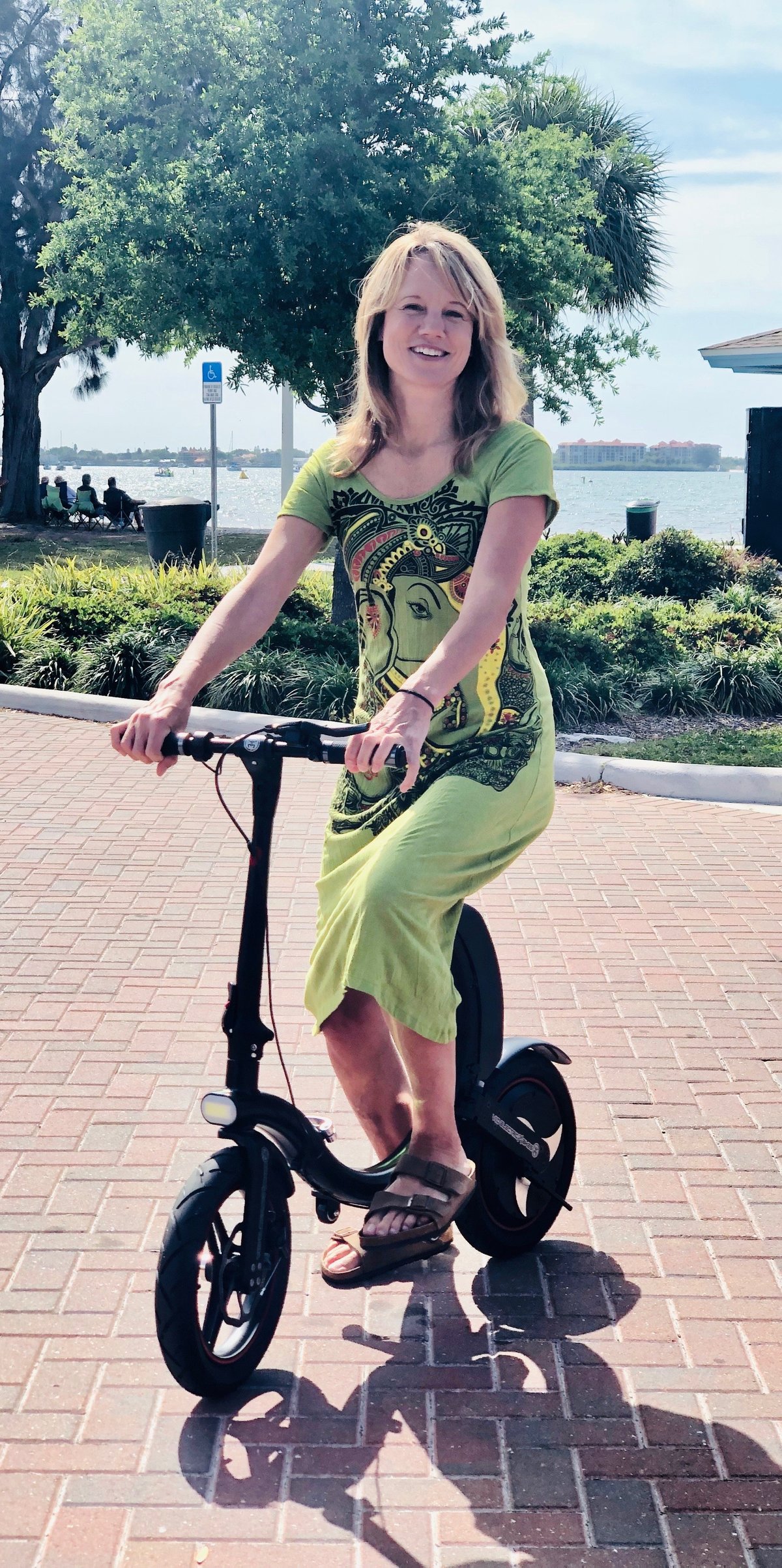 Lady in green dress on her Go-Bike Q1