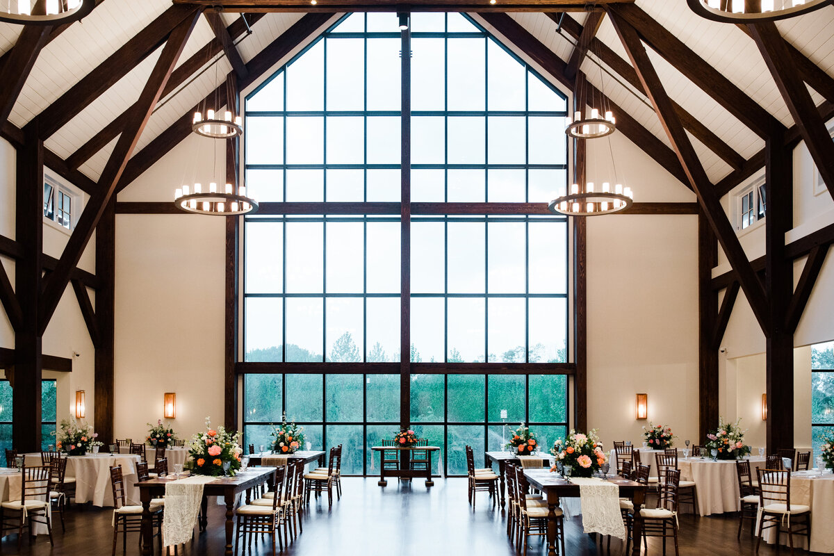 Expansive view of the reception space featuring floor to ceiling windows and wood beams