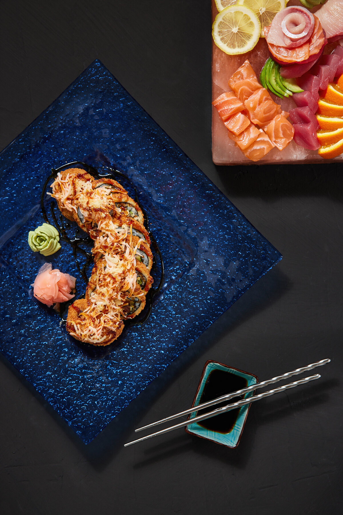 Sushi laid out on a blue plate