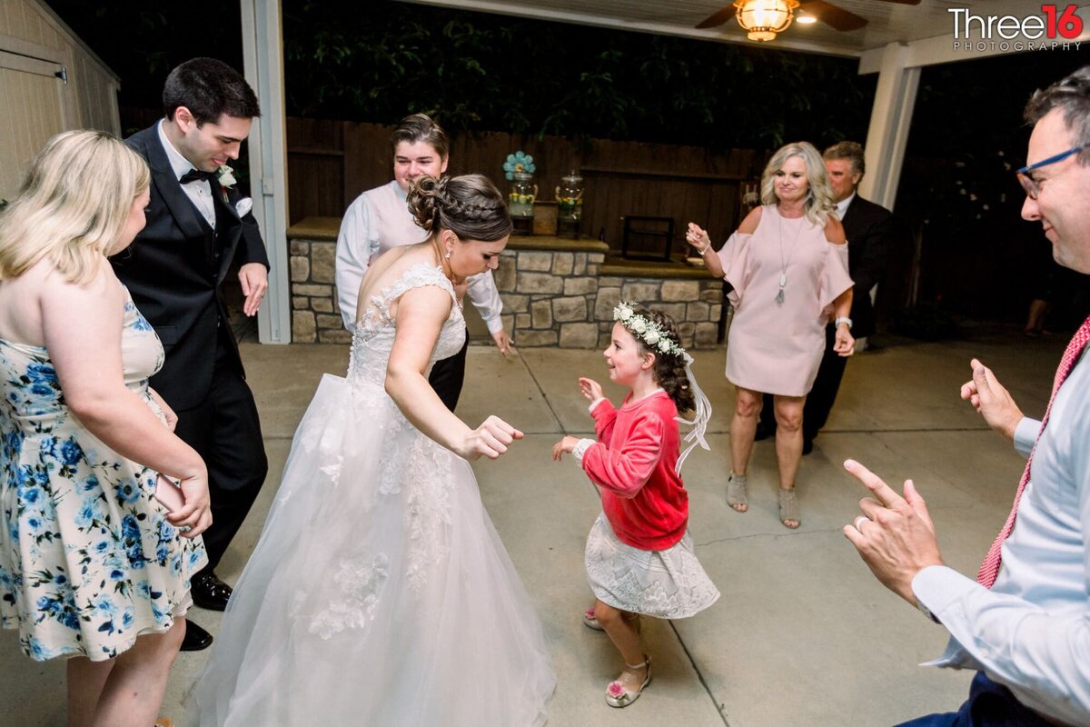 Bride dance with little girl at celebration