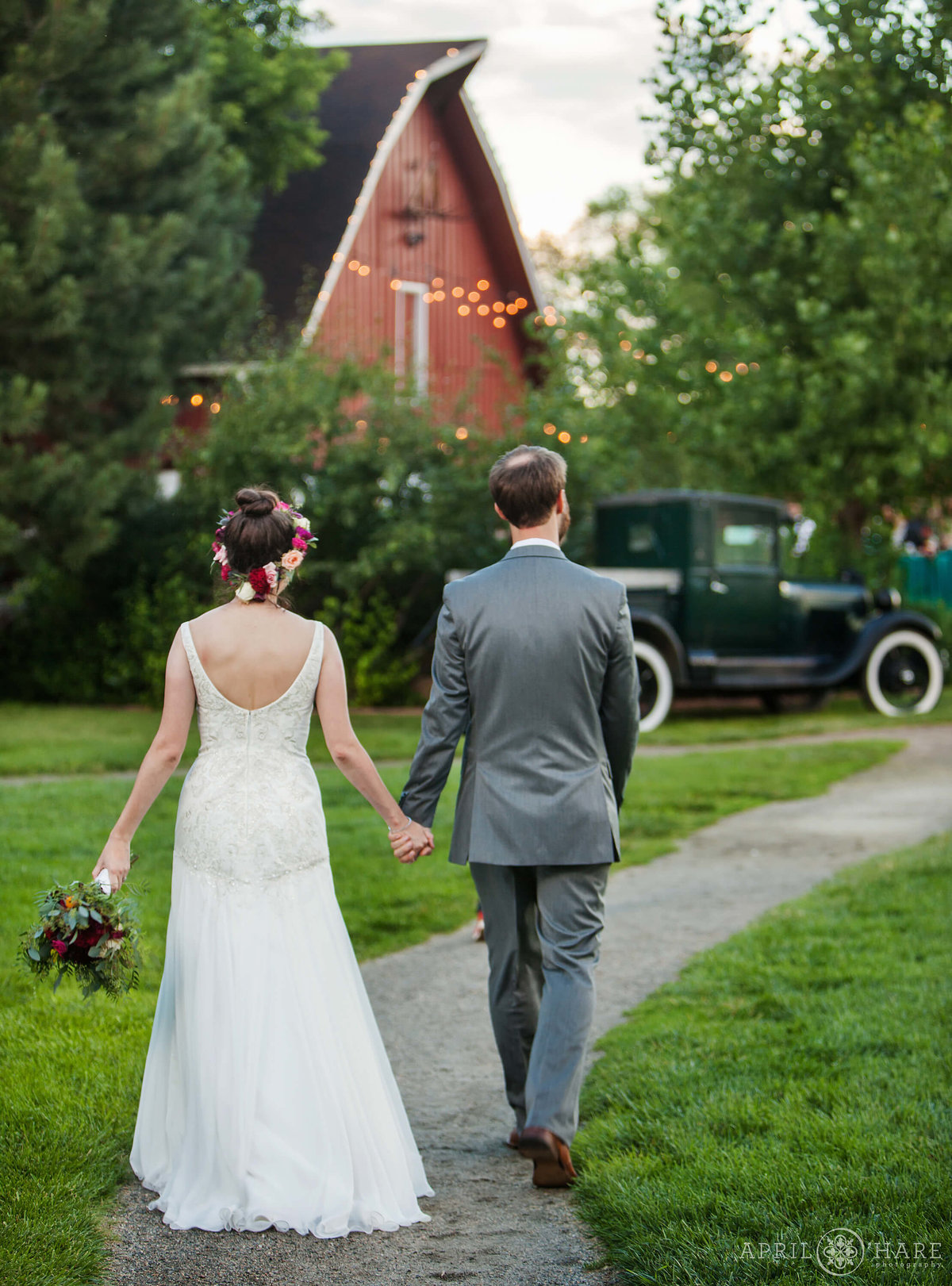Colorado Wedding Photographer Couples walks to barn reception at Chatfield Farms