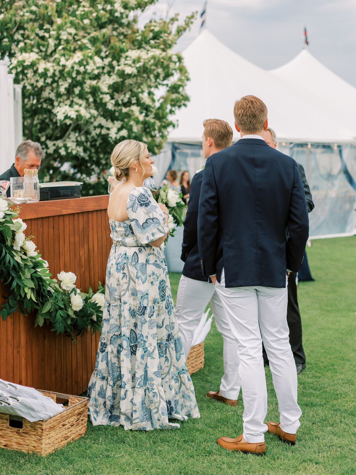 Guests in elegant garden attire mingle at cocktail hour