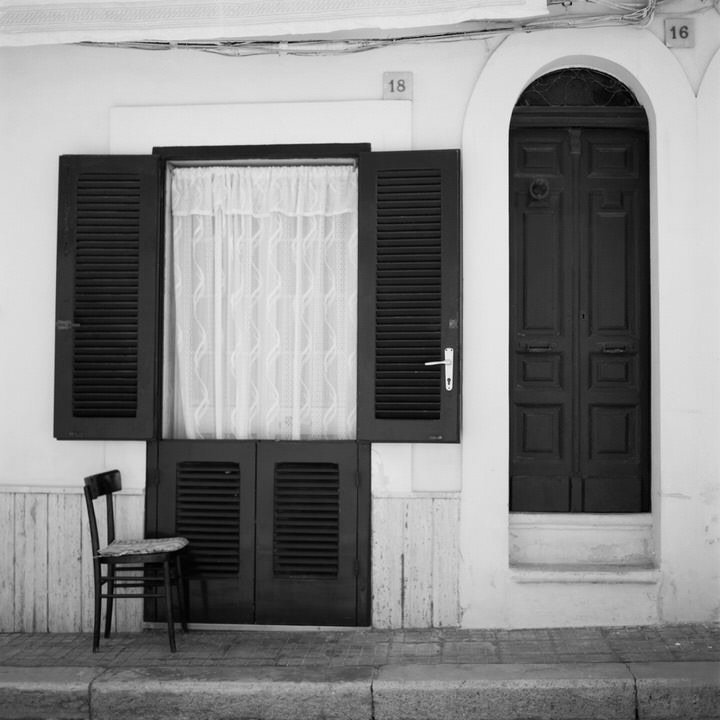 black and white photo of rom front door
