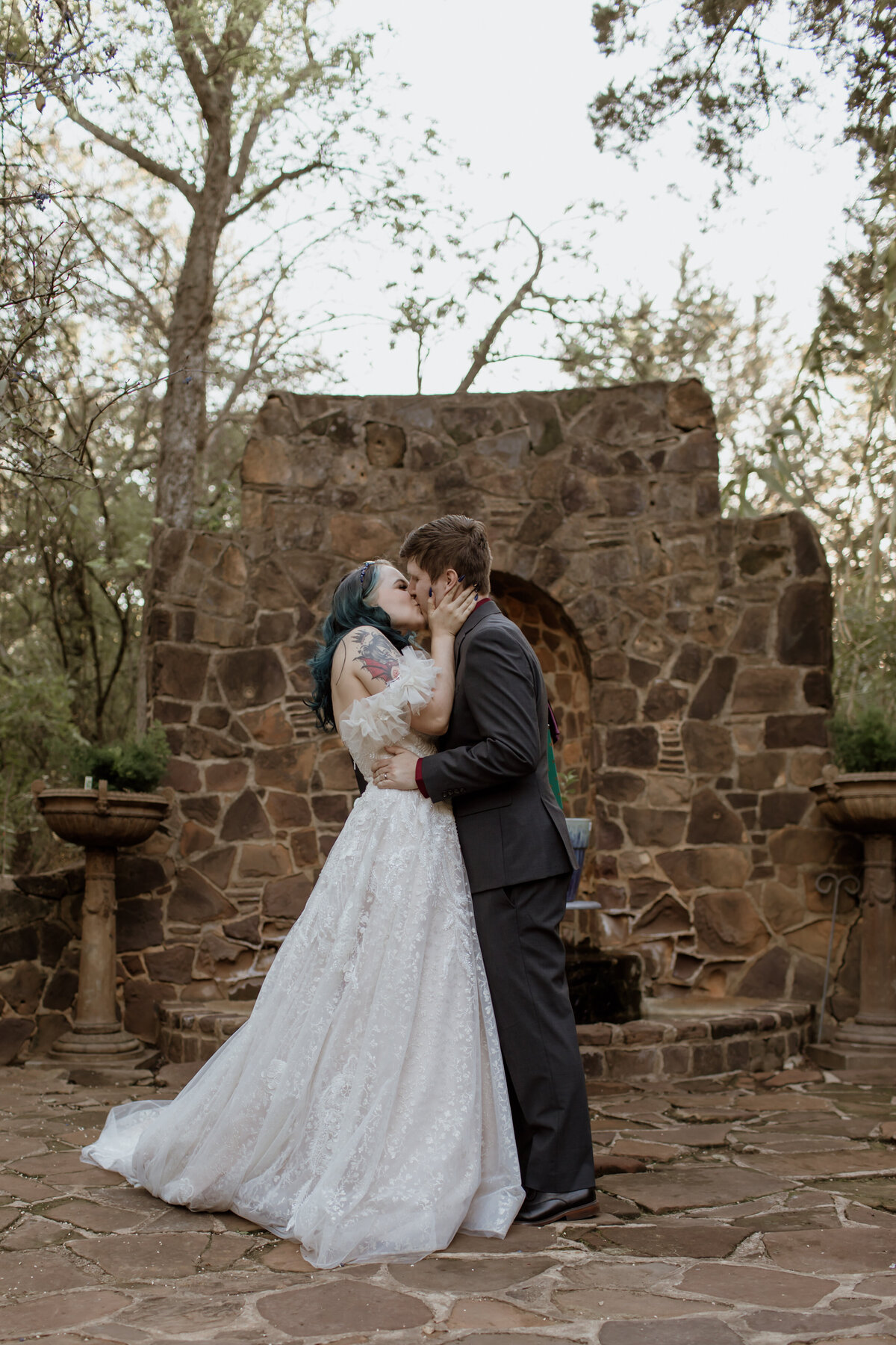 A couple shares their first kiss as husband and wife at Weston Gardens in Bloom in Fort Worth Texas. Captured by Fort Worth Wedding Photographer, Megan Christine Studio