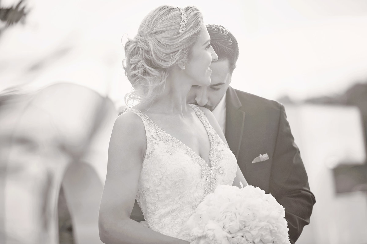 Groom kissing bride's shoulder wedding photo in black and white
