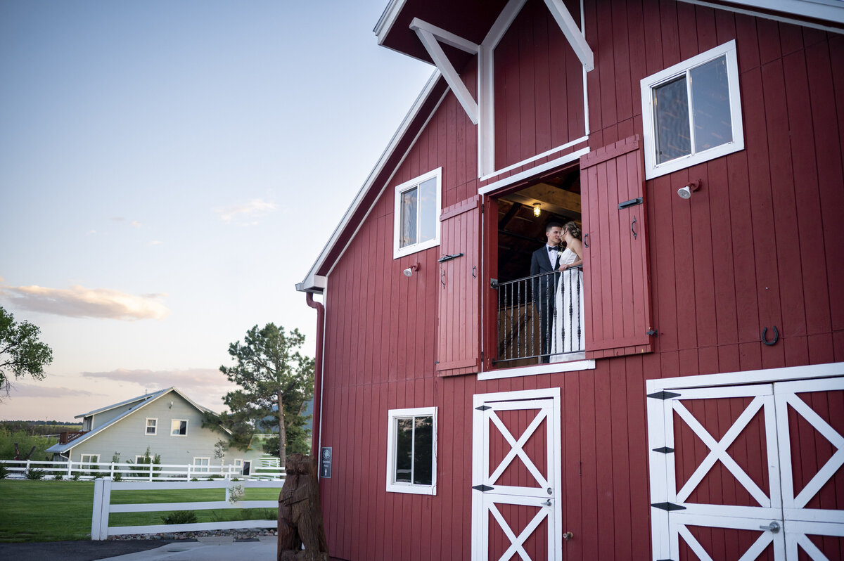 Wedding portraits at the top of the barn at venue in Monument Colorado