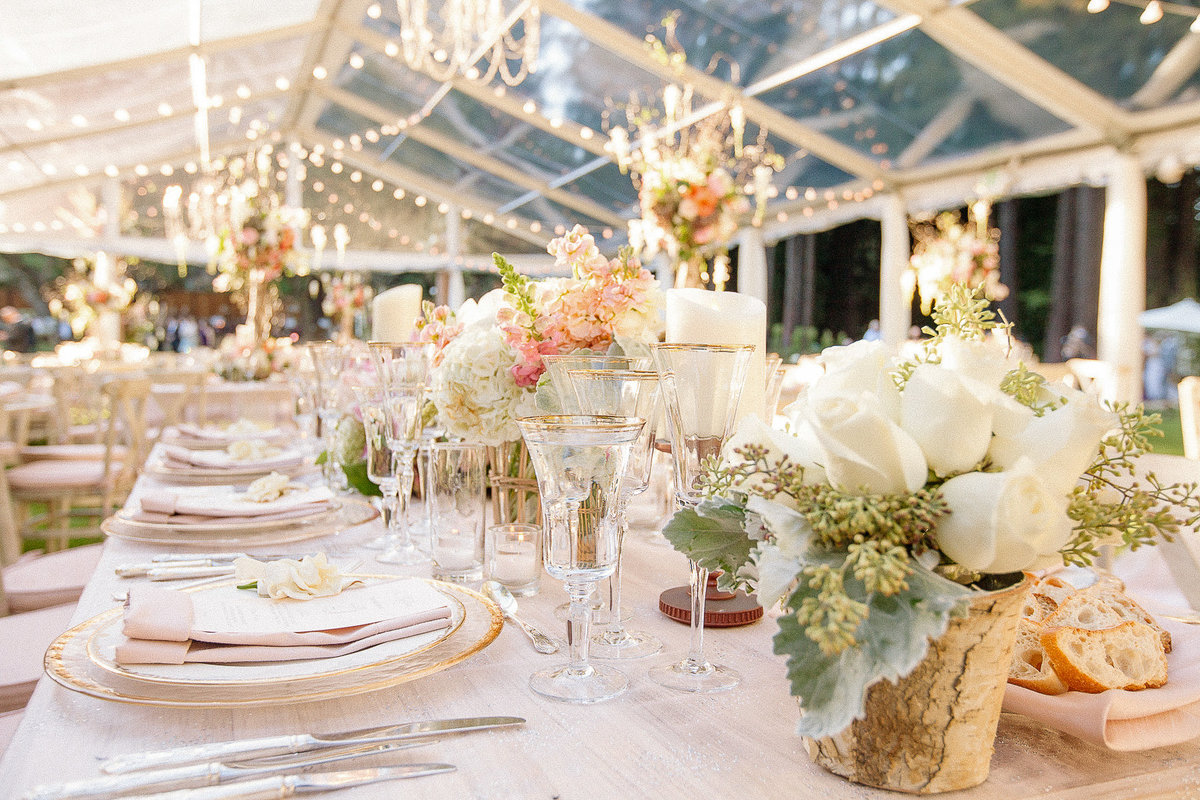 A white and blush tabletop and clear tent for a wedding at The Family Farm in Woodside, Ca.