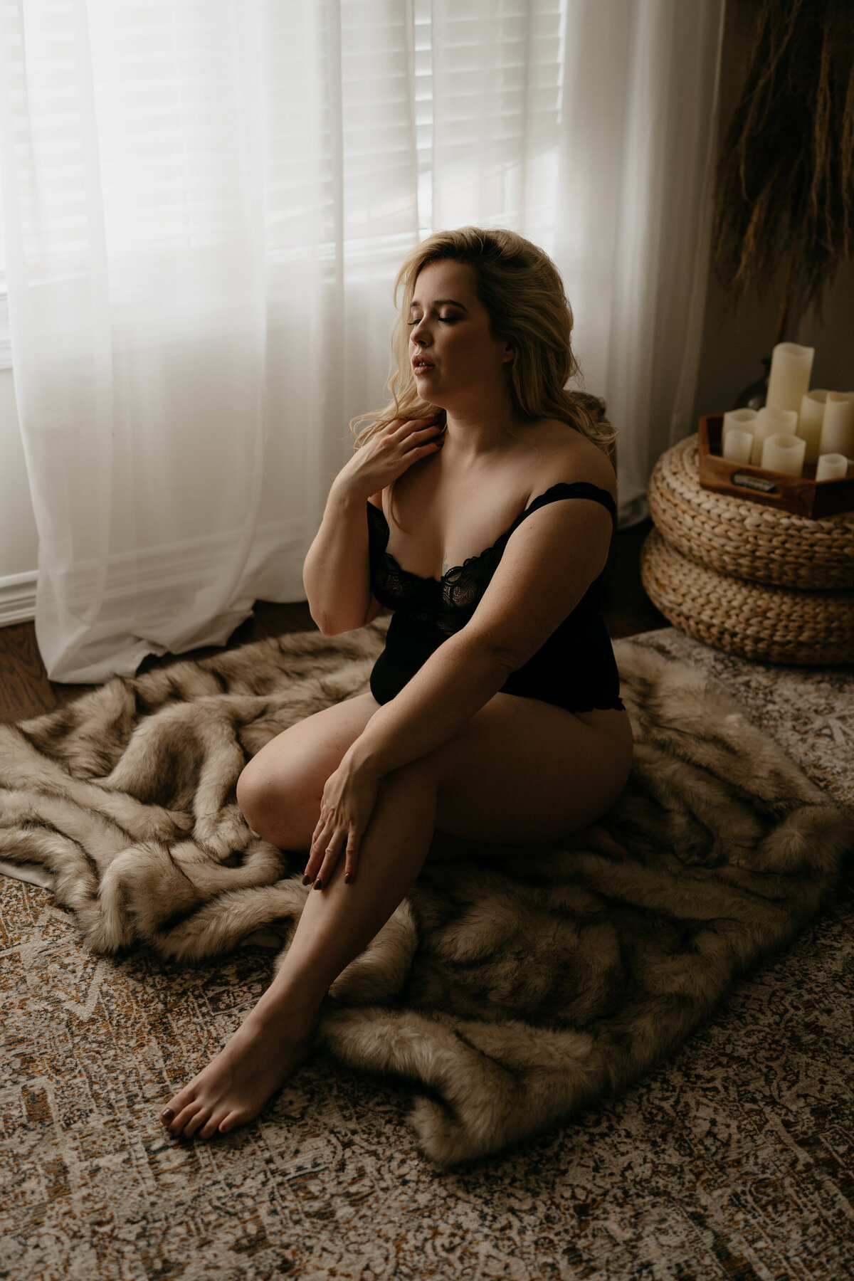 woman with blonde hair sitting on fur rug