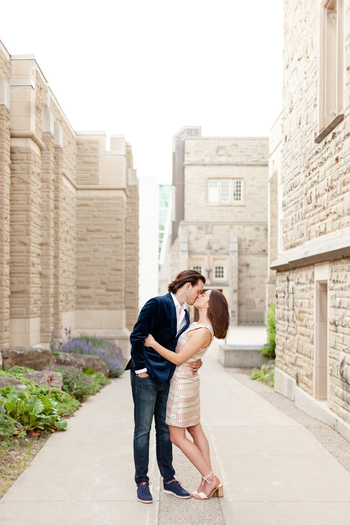 Guys-dips-his-fiance-back-in-a-romantic-walkway-between-buildings-at-western-university-in-london-ontario