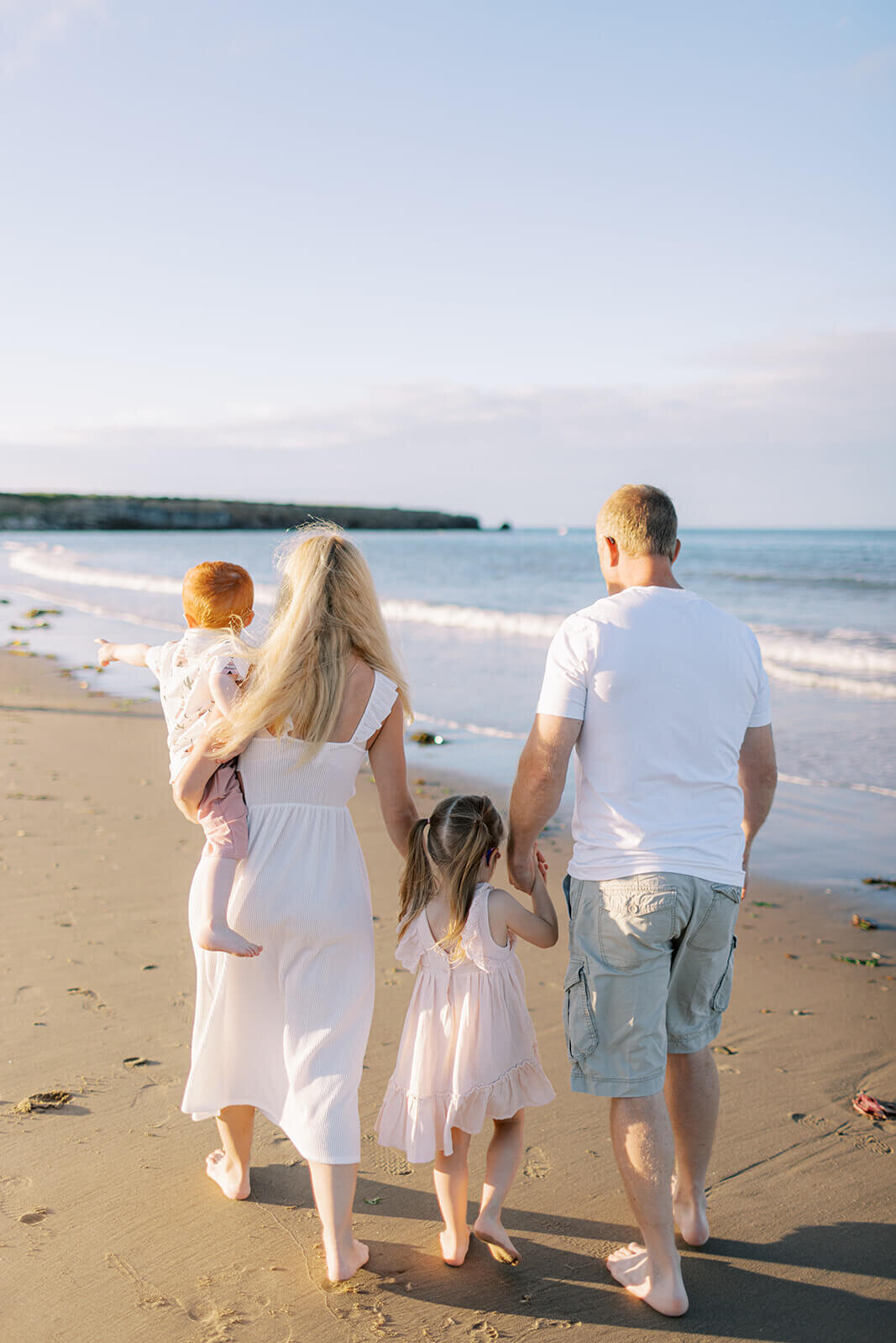 family-walking-on-beach