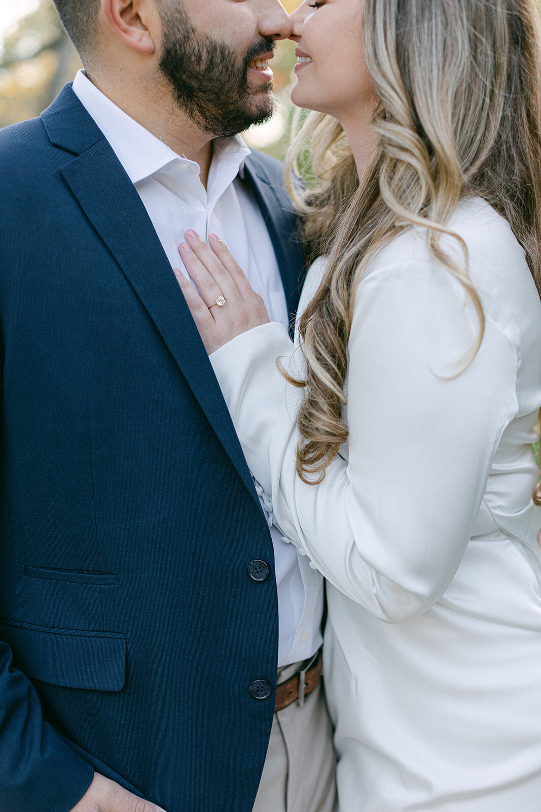 Couple embracing during golden hour engagement session in a Pittsburgh park