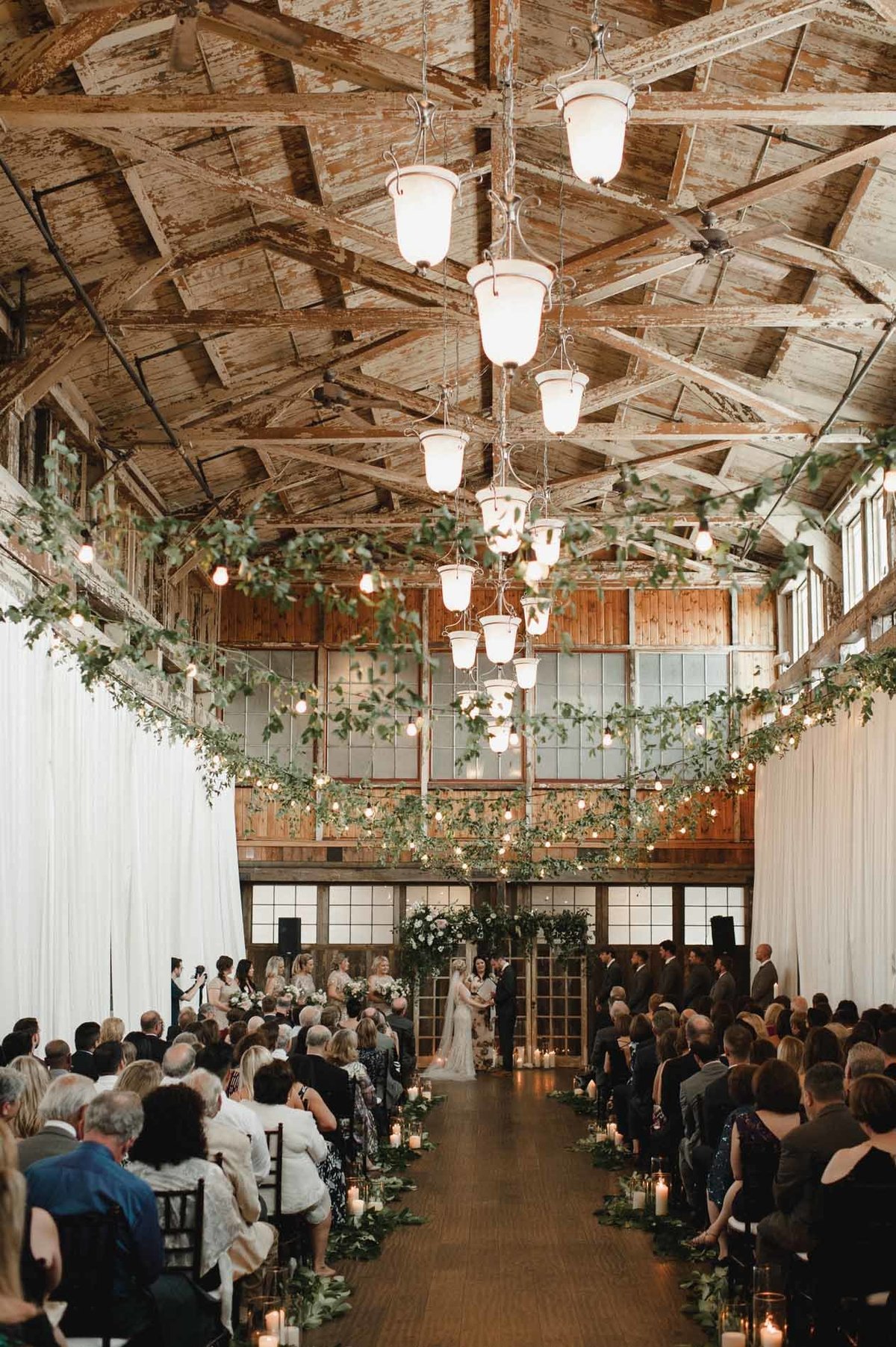 Delicate vines hang throughout the ceremony space created by Flora Nova Design in Seattle