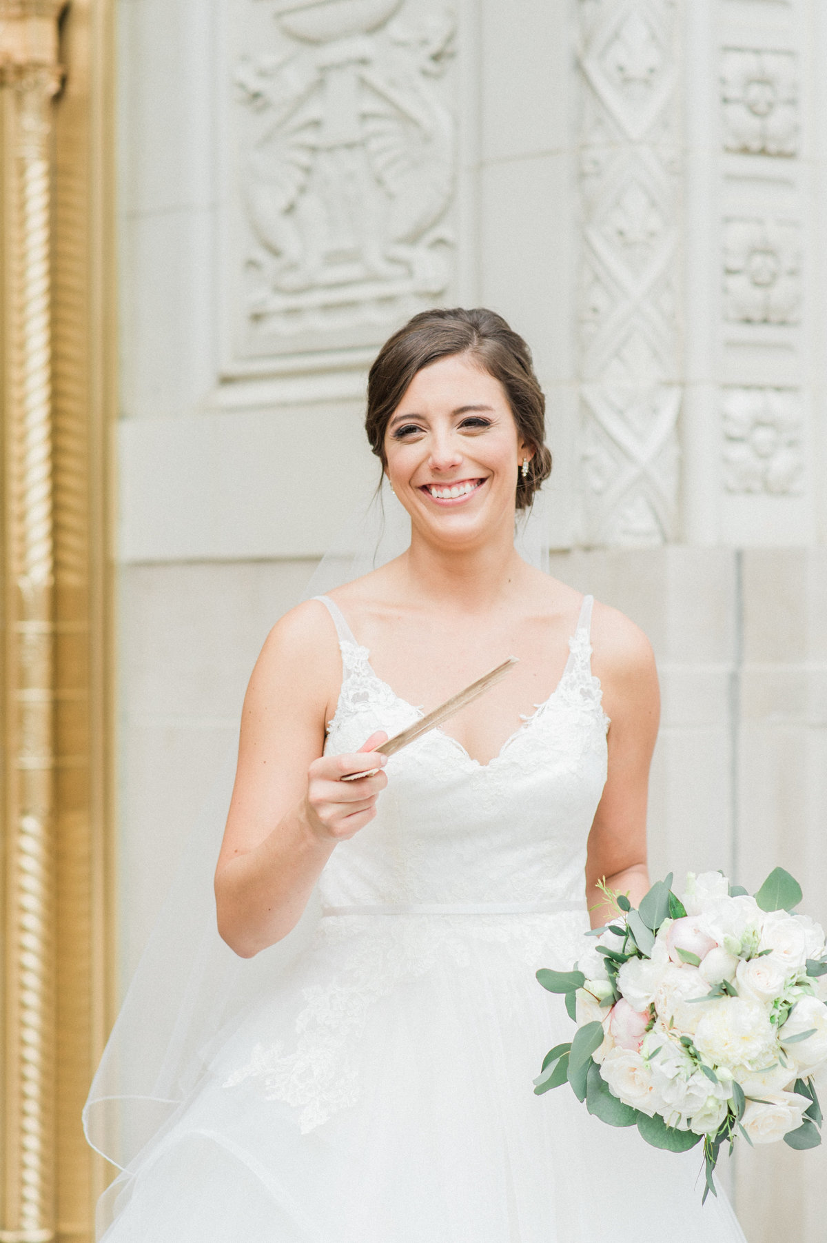 bride holding fan and smiling
