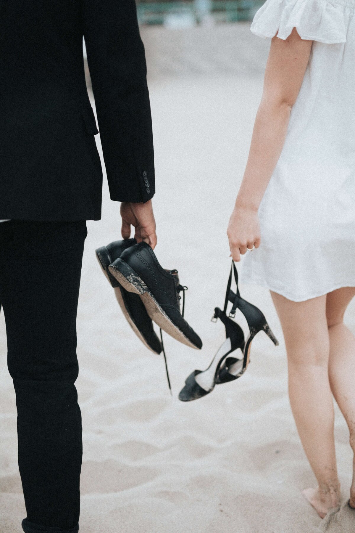 Legendary-World-Travel-by Karen-Destination-Wedding-Planner-couple-holding-shoes