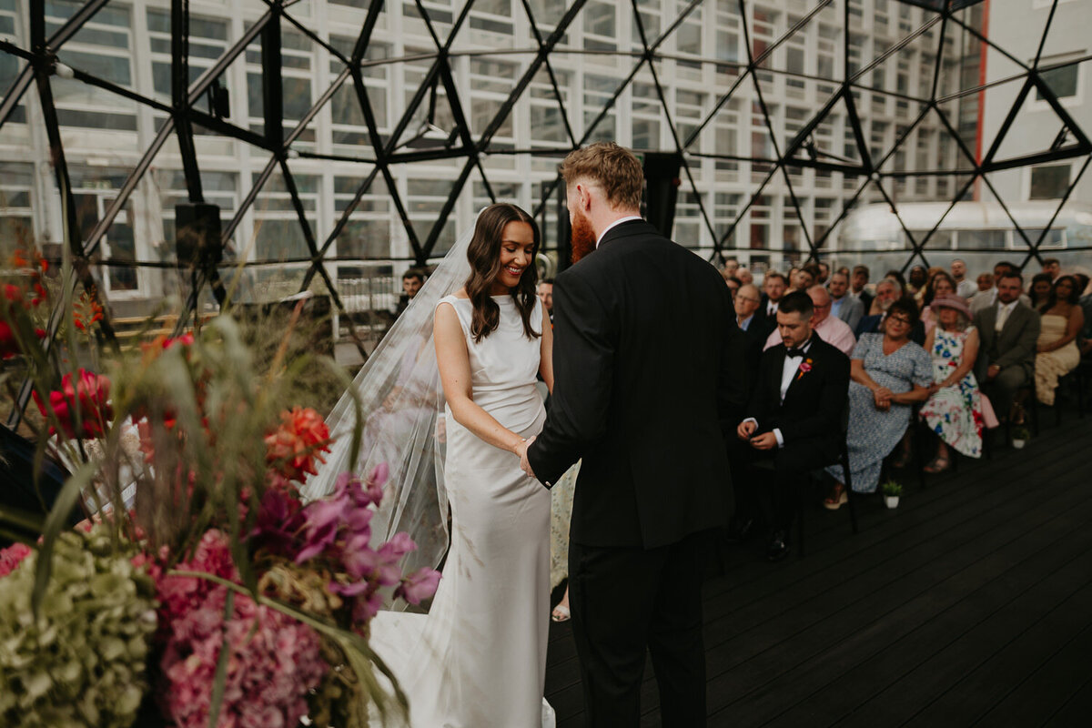 Bride and groom during their wedding ceremony at The Dome at ABC Buildings in Manchester.