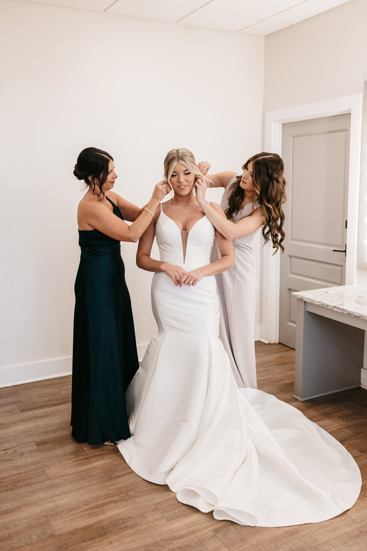Sister and Mother helping bride get ready