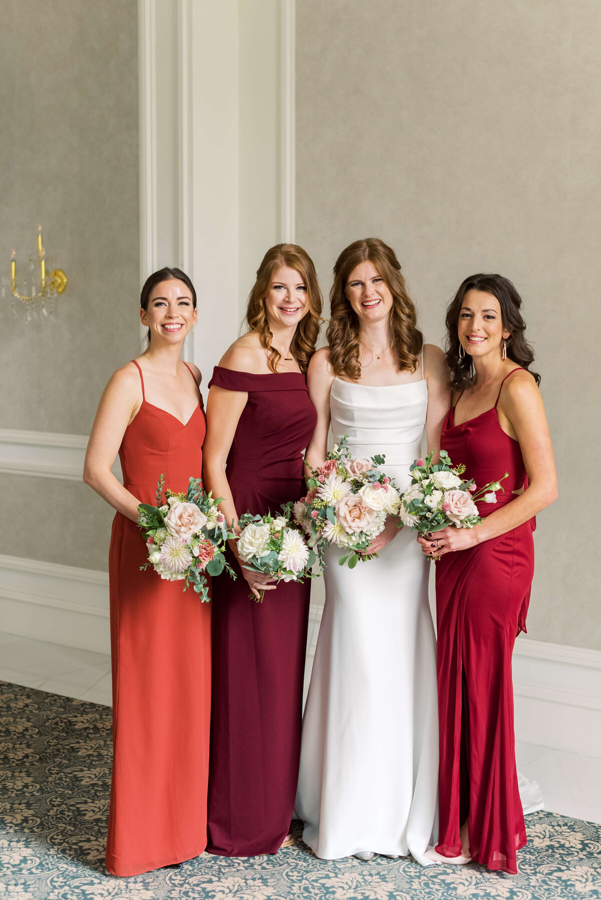 Bride with 3 bridesmaids wearing red dresses at Lord Nelson Hotel, Nova Scotia