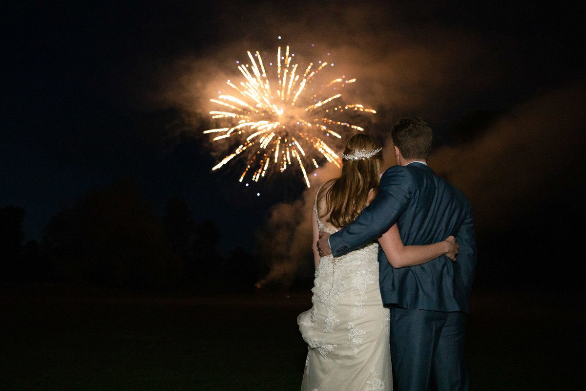 Bride and Groom with fireworks   at Forde House wedding in Somerset_