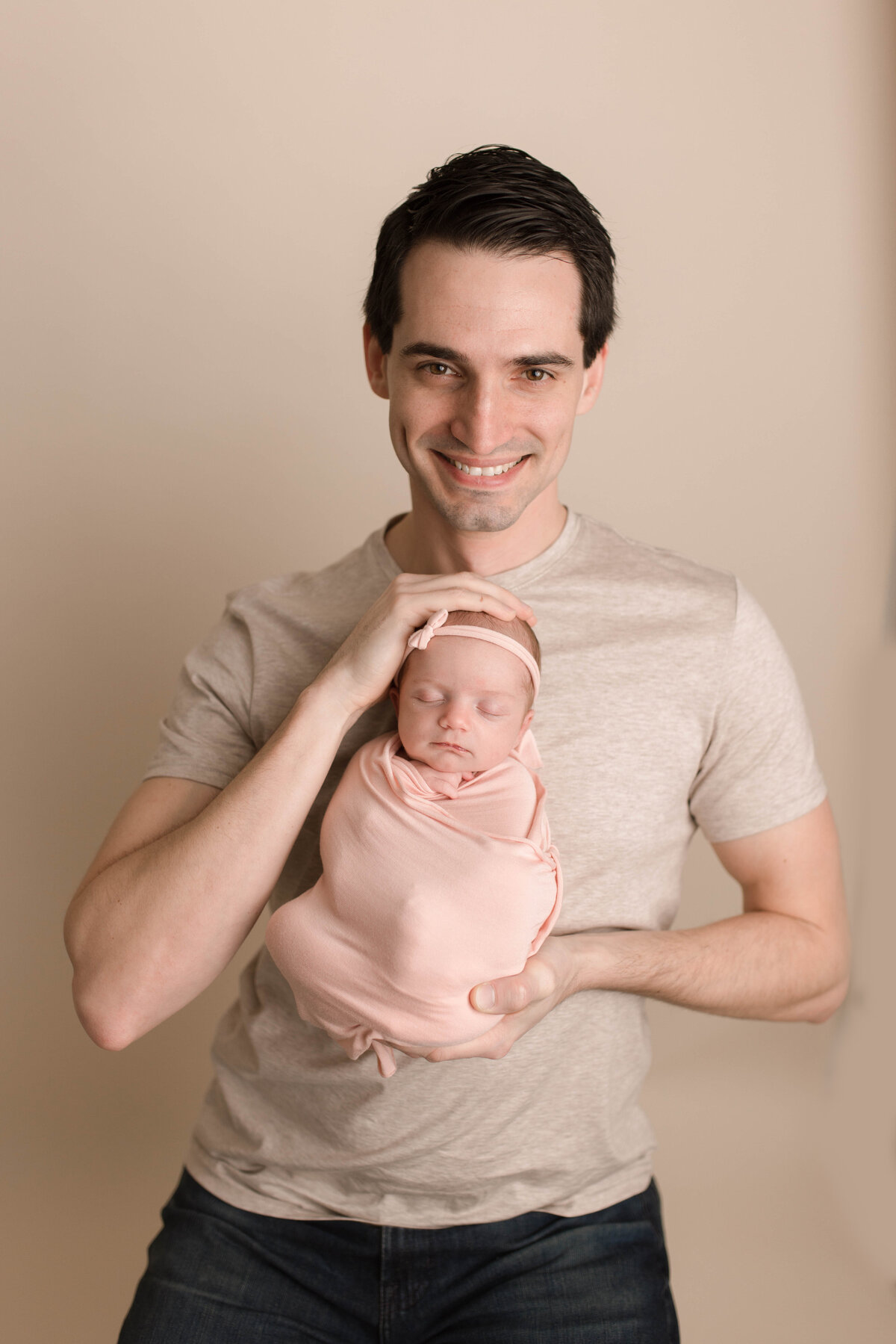 Happy dad with his newborn baby girl